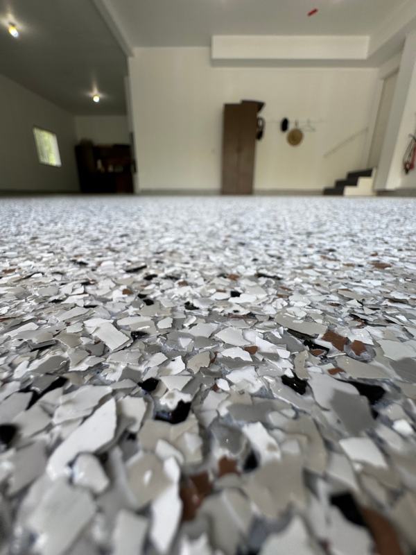 Close up of white, gray and brown flake under a clear topcoat