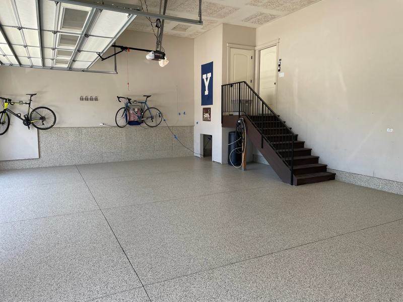 Light gray and tan flake floor with flake wall section under hanging bikes