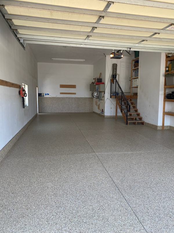 Long tan flake garage floor with flake wall section at the back