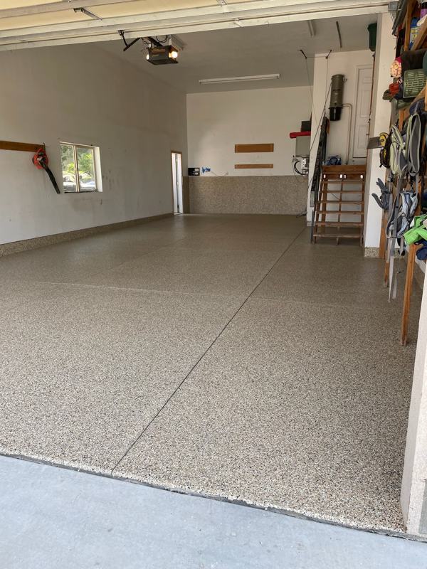 Tan flake garage floor with a flake edge at the driveway